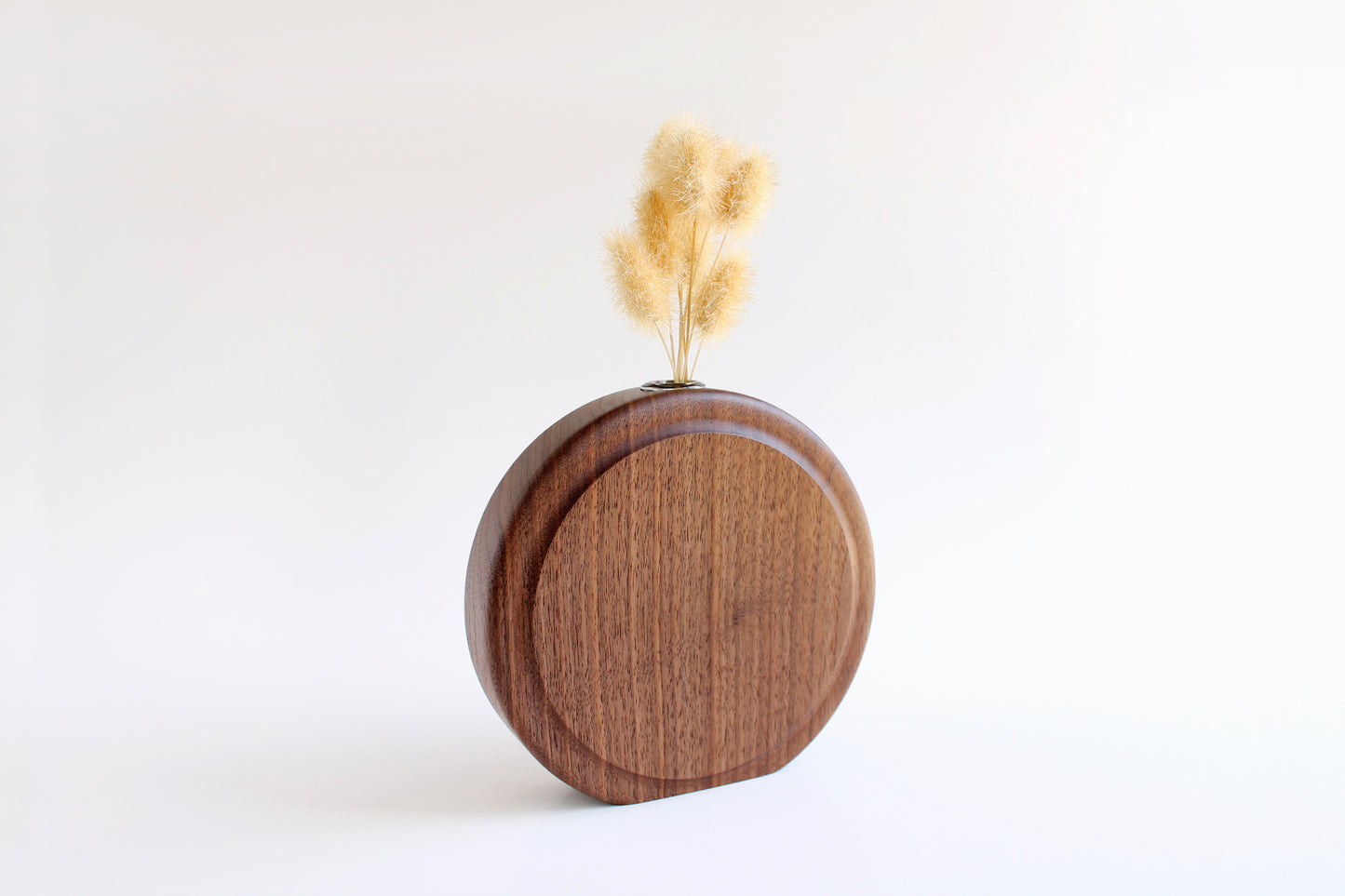 Walnut Circle Vase with Test tube for wet or dry flowers. Dried flowers shown in vase. Angled View