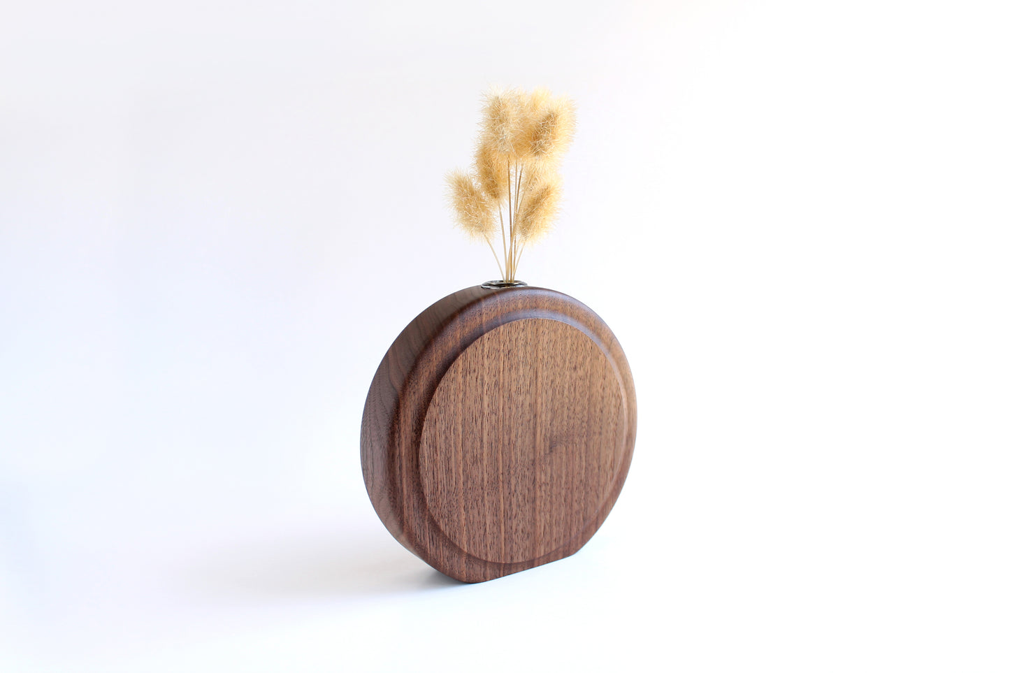 Walnut Circle Vase with Test tube for wet or dry flowers. Dried flowers shown in vase. Vase shown at more angled view