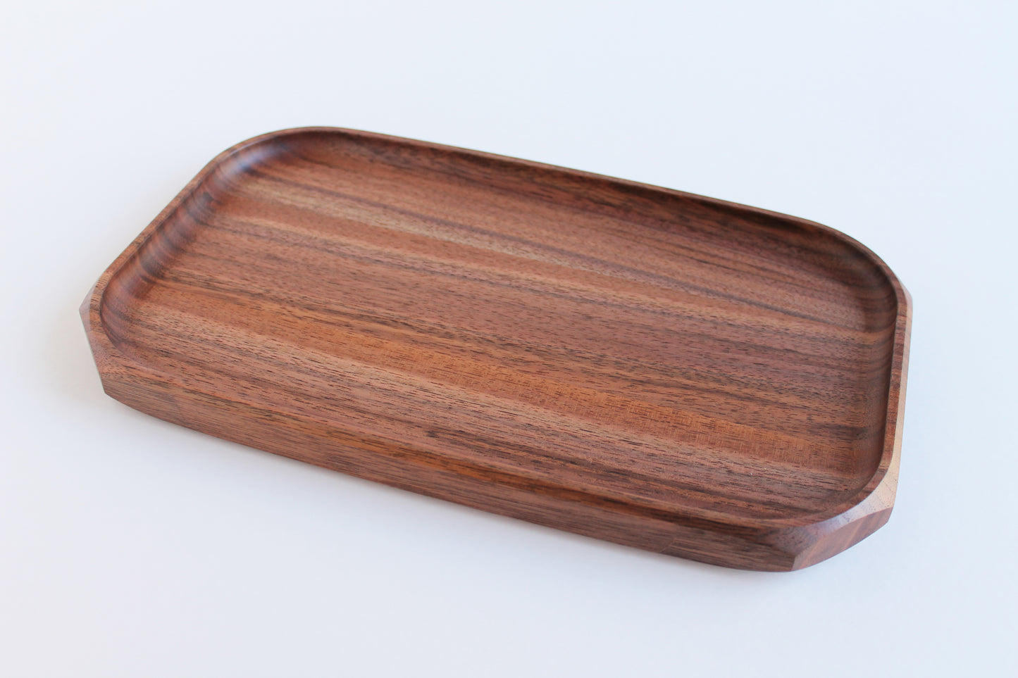 Genesis Tray in Walnut wood on white background. Angled view