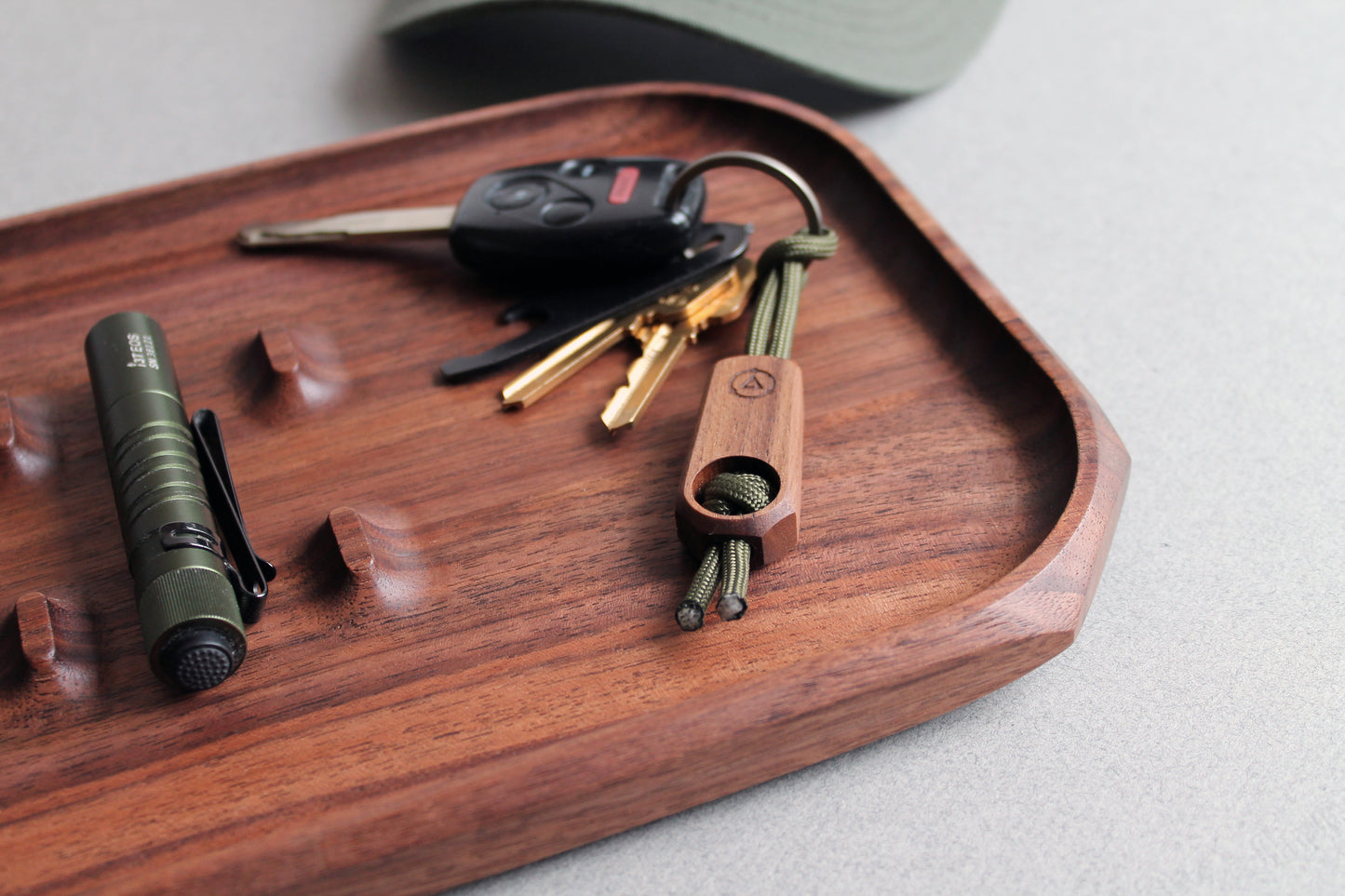 Core Key Fob in Walnut with Olive Green Lanyard on Walnut tray