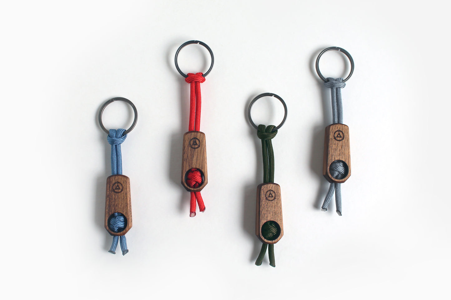 Core Key Fob with Titanium Key Ring, Paracord Lanyard with Walnut or Maple Fob. Multiple Key Fobs shown in walnut with Red, Silver, Olive and Steel Blue lanyards.