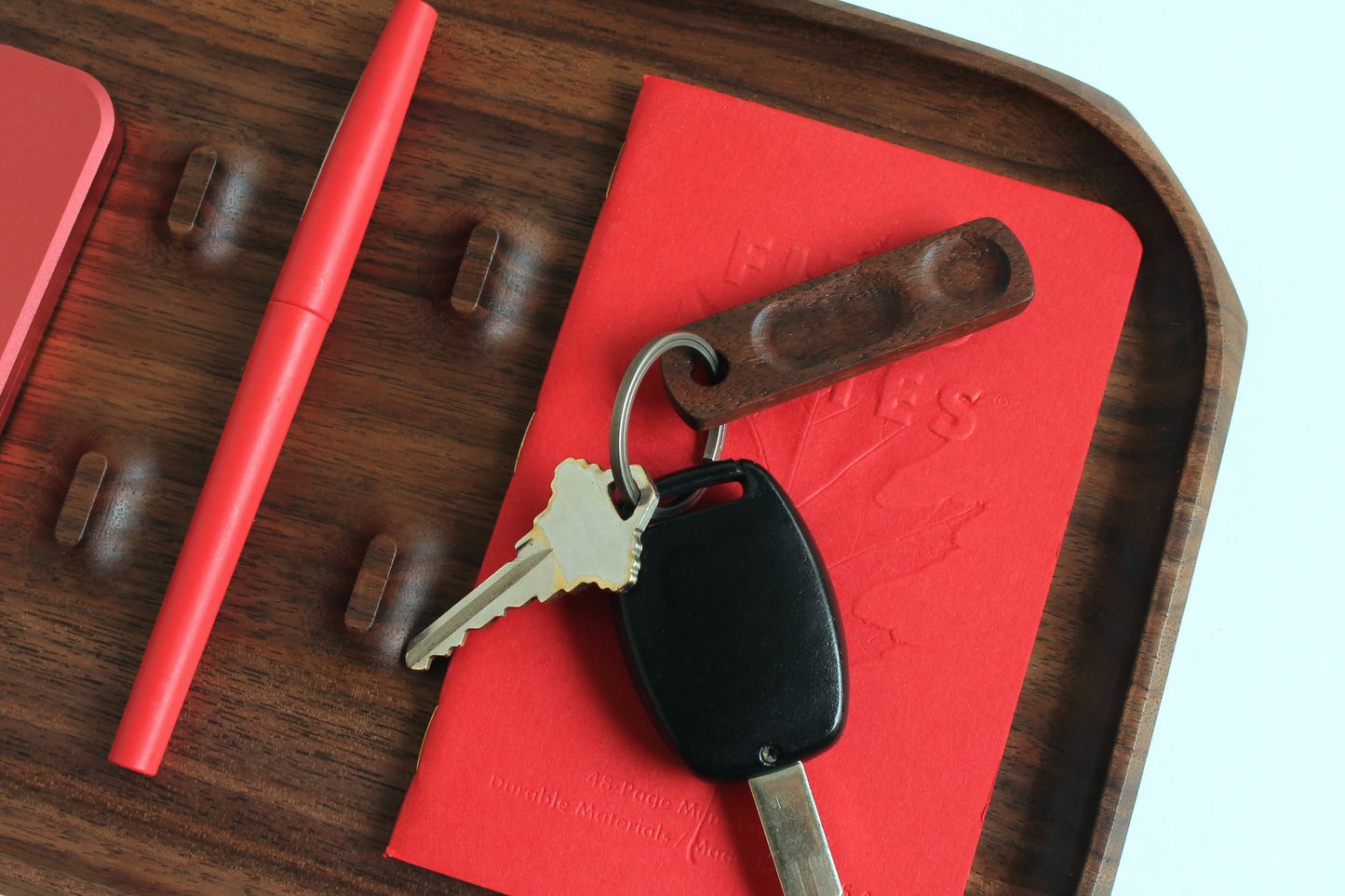 Thumbhill shown in Walnut with Titanium key ring on EDC Park Tray with keys, notebook and pen.