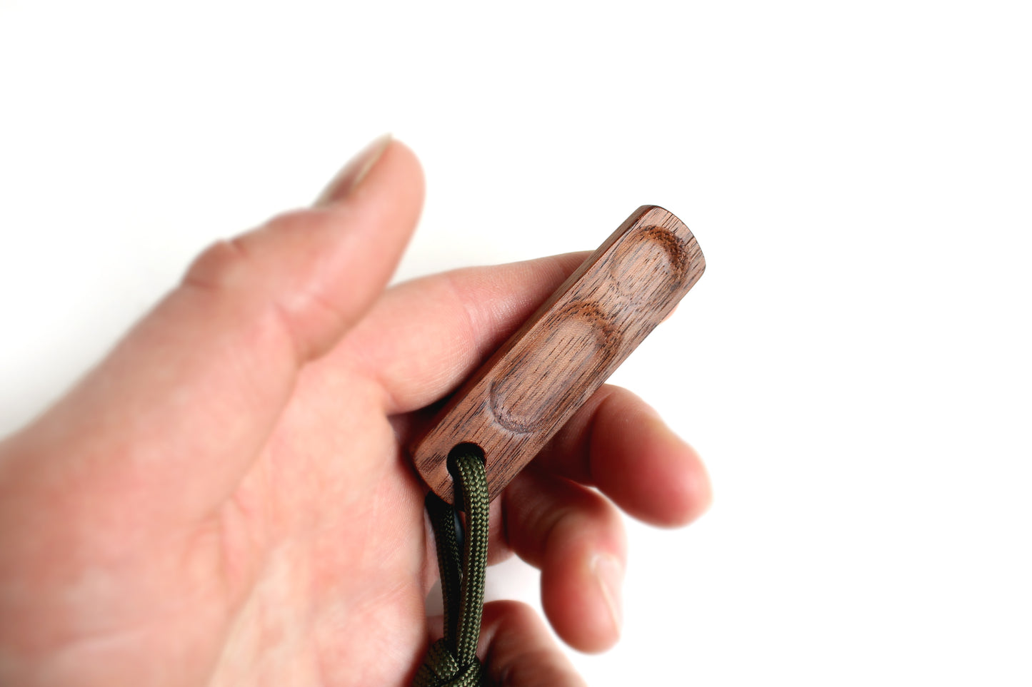 Thumbhill in Walnut held in persons hand open with lanyard at bottom.