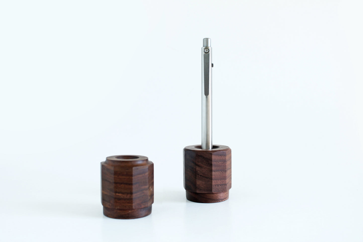 Walnut pen holder with chamfer edge with titanium pen and second pen holder with half round edge