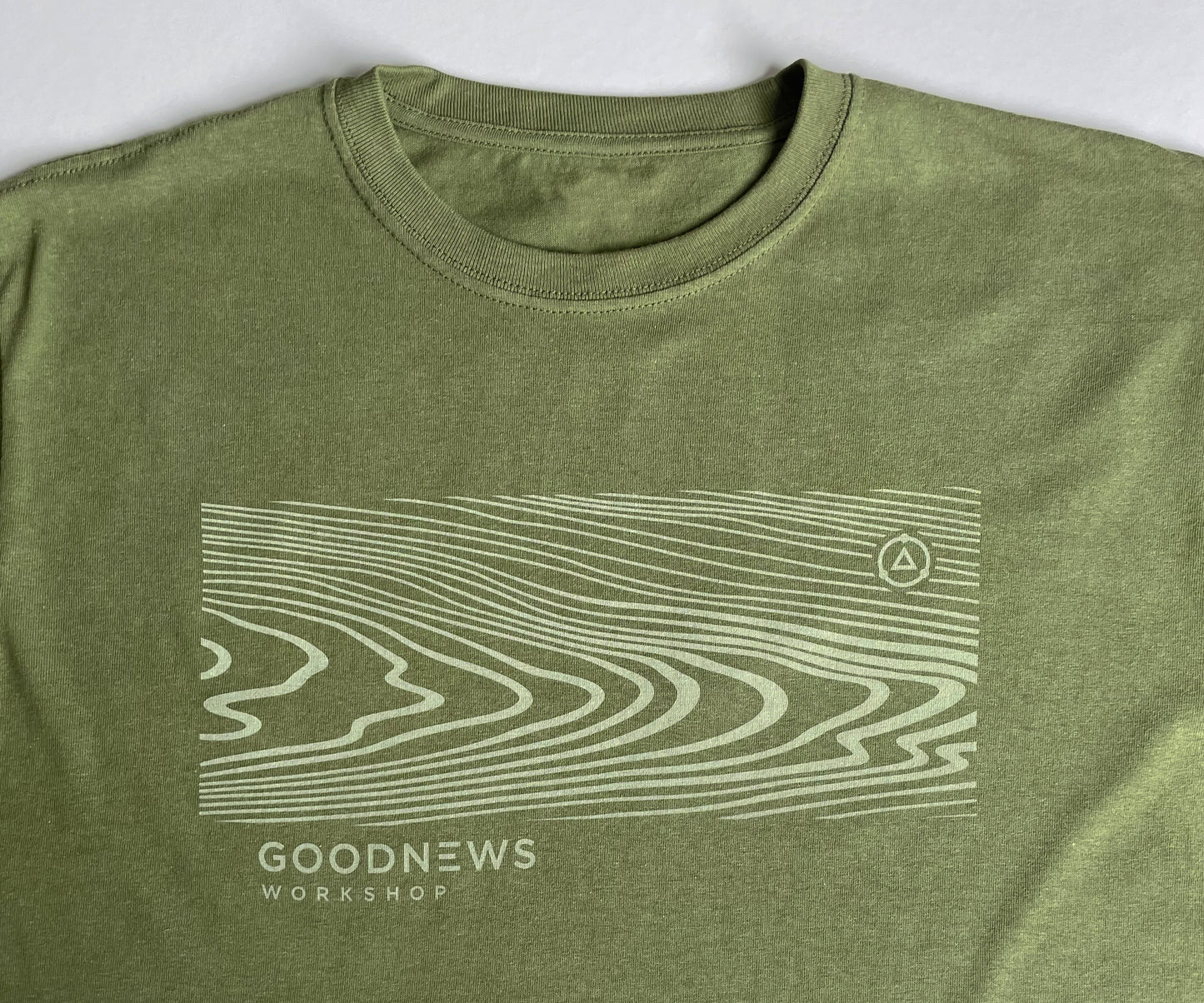Earth Olive Green Grain T Shirt detailed view of walnut grain graphic in on tone lighter green water based ink.